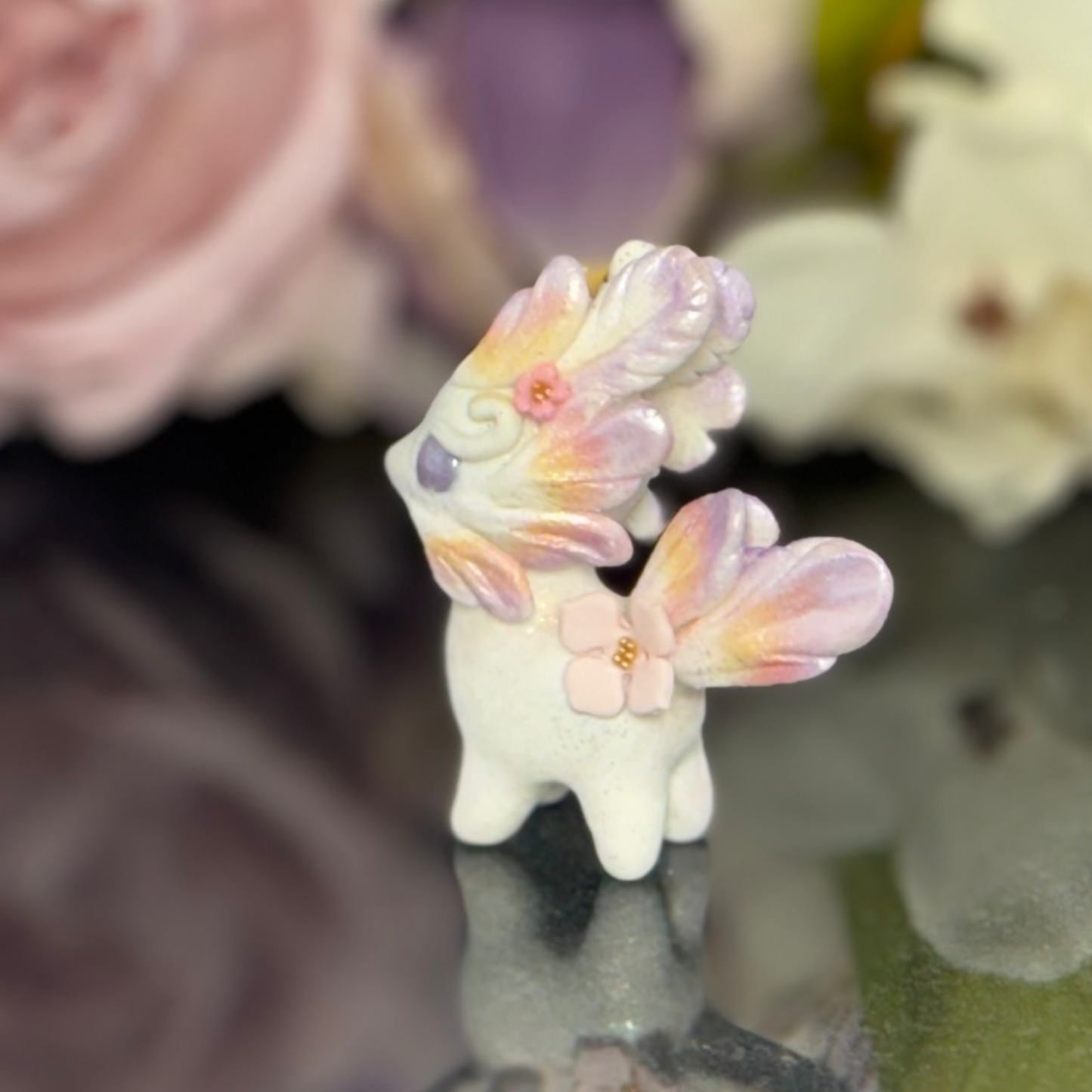 Tiny Purple, Orange gold and Pink wingless Bunnigon