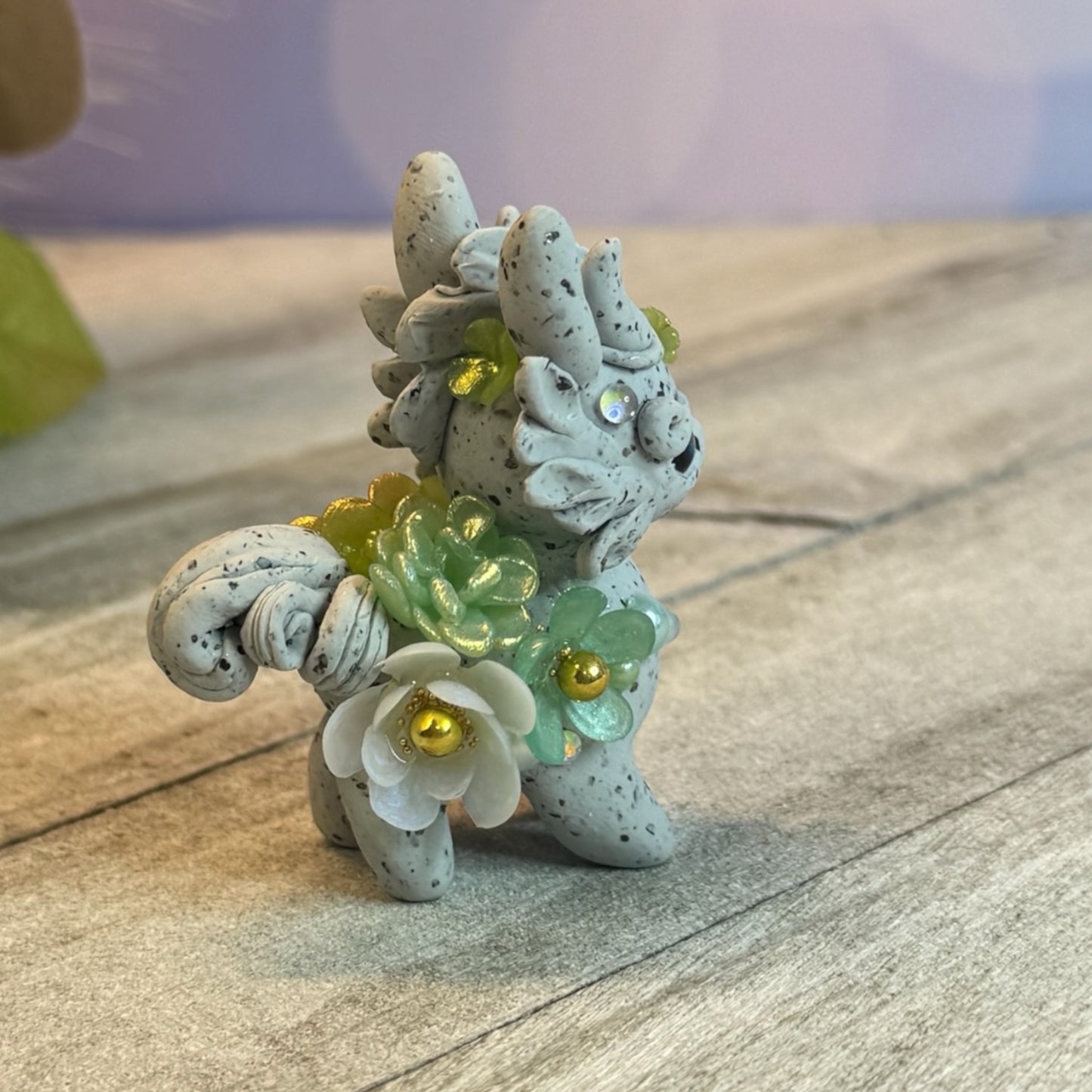 Small Stone Bunnigon with Green and White Flowers