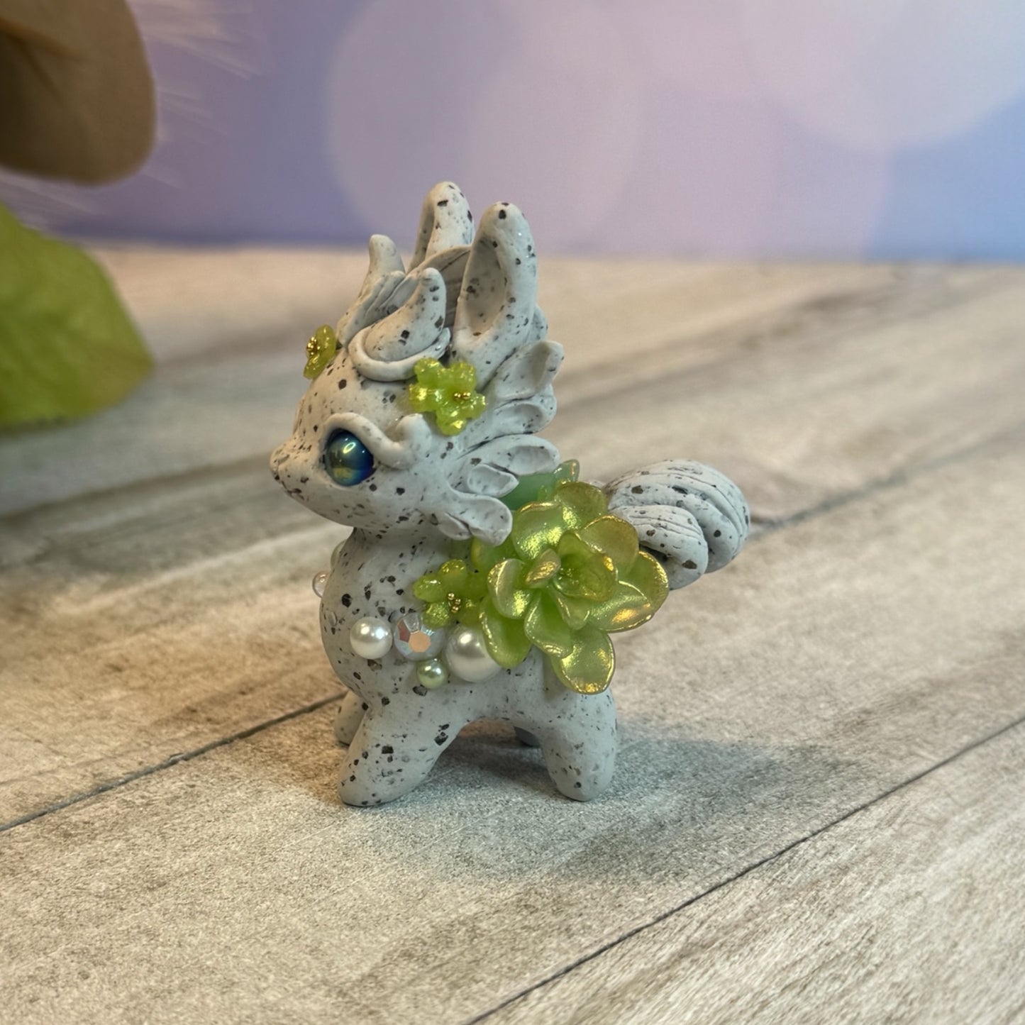 Small Stone Bunnigon with Green and White Flowers