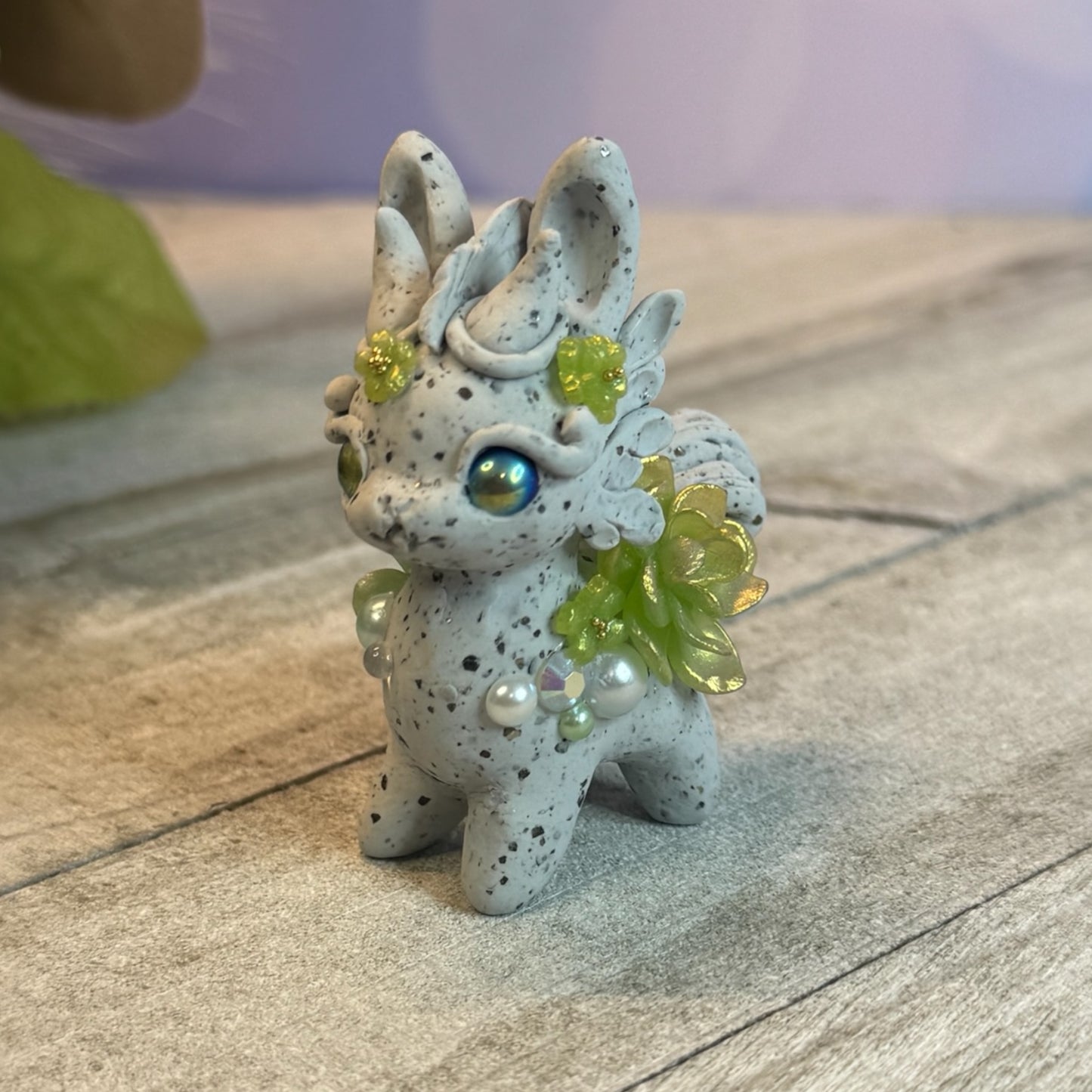 Small Stone Bunnigon with Green and White Flowers