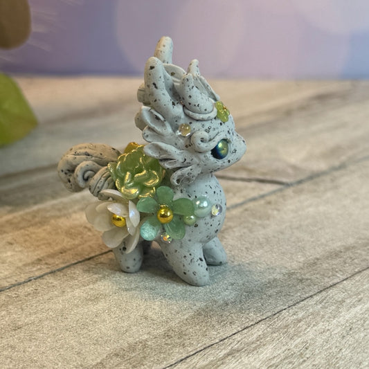 Small Stone Bunnigon with Green and White Flowers